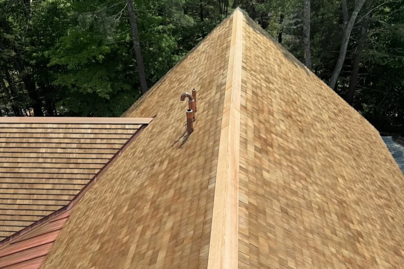 Cedar shingle roof with copper valley flashing on a pyramidal turret in Greater Boston