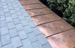 Copper standing seam meeting slate roof ma