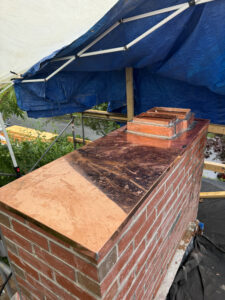 Custom copper chimney crown hand soldered on site