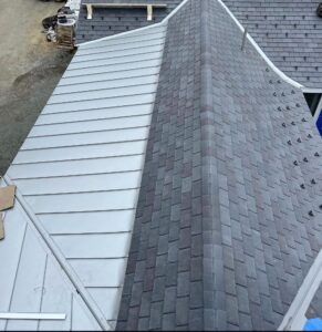 Freedom Gray standing seam copper roof meeting slate roofing at the ridge, custom fabricated by Paul John & Son