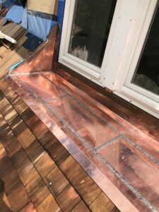 Soldered flat seam copper roof window apron ma
